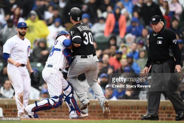 Nicky Delmonico of the Chicago White Sox is tagged out at home plate by Willson Contreras of the Chicago Cubs during the fifth inning of a game at...