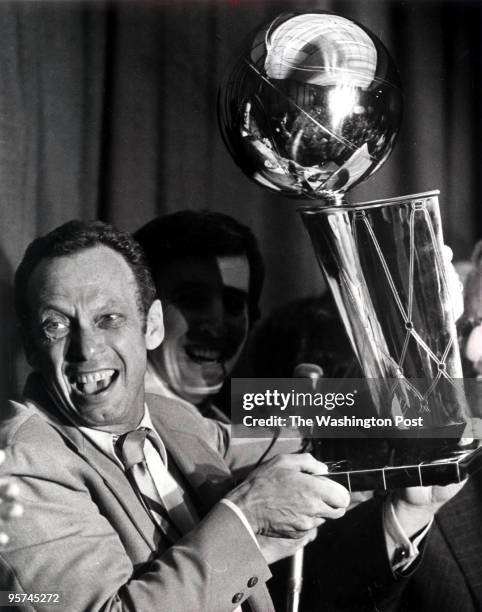 Bullets/Wizards owner Abe Pollin holds the NBA Championship trophy after his team's win in 1978.