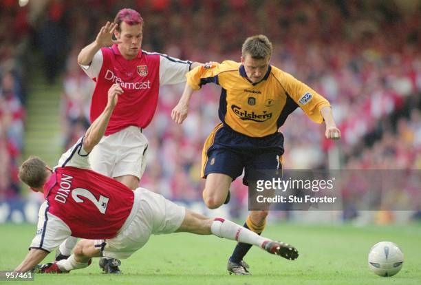 Vladimir Smicer of Liverpool takes on Arsenal's Fredrik Ljungberg and Lee Dixon during the AXA sponsored FA Cup Final between Arsenal and Liverpool...
