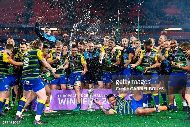 Cardiff Blues players celebrate with champagne after winning the 2018 European Challenge Cup final rugby union match against Gloucester at the San...