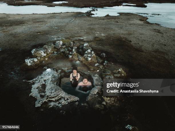 aerial view of couple in hot spring in iceland - thermal pool stock pictures, royalty-free photos & images