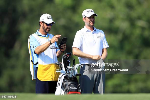 Webb Simpson of the United States talks with his caddie Paul Tesori on the 14th hole during the second round of THE PLAYERS Championship on the...