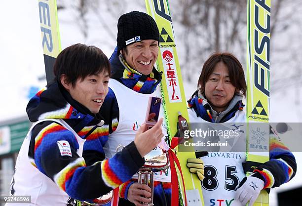 Runner-up Daiki Ito, Winner Noriaki Kasai and third place Takanobu Okabe smile on the podium after the STV Cup at the Okurayama Jump Stadium on...