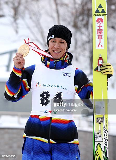 Winner Noriaki Kasai poses for photographs on the podium after the STV Cup on the Okurayama Jump Stadium on January 10, 2010 in Sapporo, Hokkaido,...