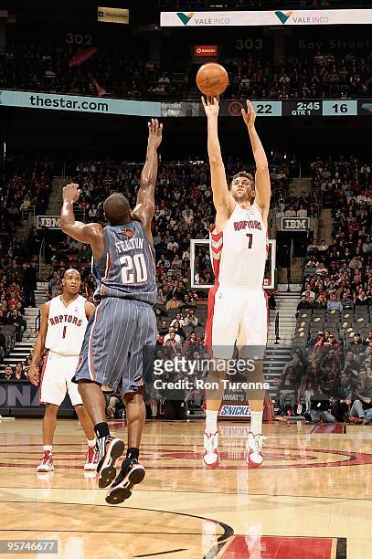 Andrea Bargnani of the Toronto Raptors shoots a jumper against Raymond Felton of the Charlotte Bobcats during the game on December 30, 2009 at Air...