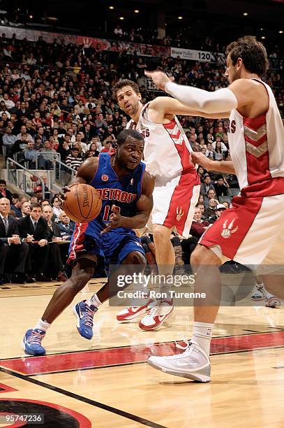 Will Bynum of the Detroit Pistons drives the ball against Marco Belinelli of the Toronto Raptors during the game on December 27, 2009 at Air Canada...