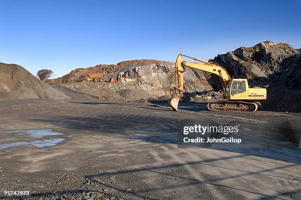 scenic shot of a quarry being dug - caterpillar stock pictures, royalty-free photos & images