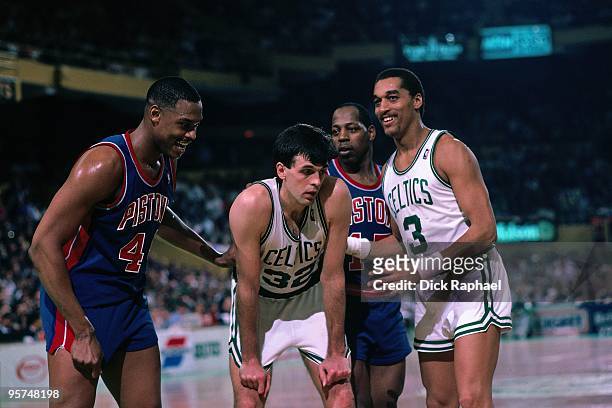 Kevin McHale and Dennis Johnson of the Boston Celtics stand against Rick Mahorn and Vinnie Johnson and the Detroit Pistons during a game played in...