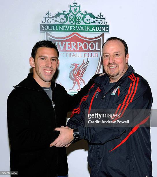 New signing Maxi Rodriguez of Liverpool shakes hands with manager Rafael Benitez at Melwood training ground on January 13, 2010 in Liverpool, England.