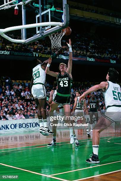 Jack Sikma of the Milwaukee Bucks shoots a layup against Robert Parish of the Boston Celtics during a game played in 1987 at the Boston Garden in...