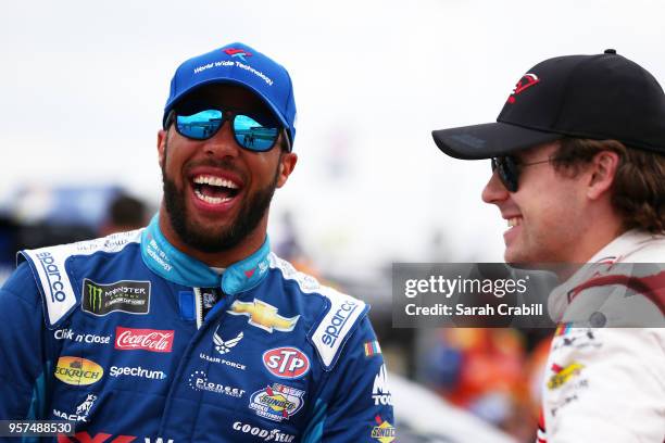 Ryan Blaney, driver of the REV Group Ford, and Darrell Wallace Jr., driver of the World Wide Technology Chevrolet, talk on the grid during qualifying...