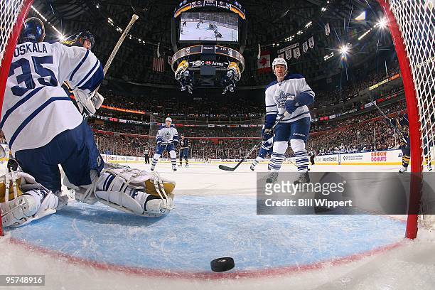 Garnet Exelby and Vesa Toskala of the Toronto Maple Leafs watch the puck slide into the net for a goal by the Buffalo Sabres on January 8, 2010 at...