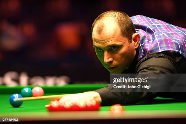 Joe Perry of England takes a shot in his second round match against Ryan Day of Wales during the PokerStars Masters snooker tournament at Wembley...