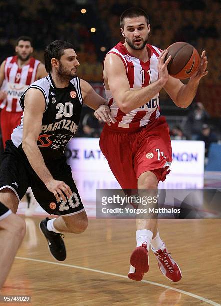 Linas Kleiza, #11 of Olympiacos Piraeus competes with Petar Bozic, #20 of Partizan Belgrade during the Euroleague Basketball Regular Season 2009-2010...