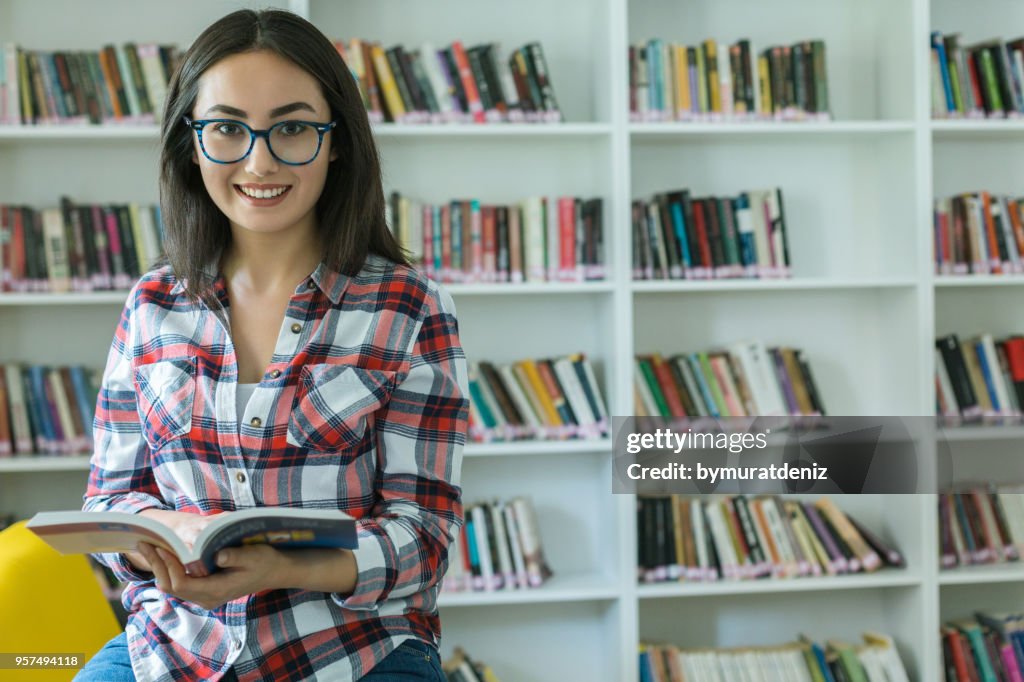 Library Woman Woman In The Library Reading A Book High-Res Stock Photo - Getty Images