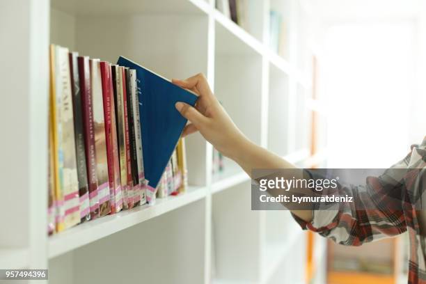 student choose book - choosing a book stock pictures, royalty-free photos & images