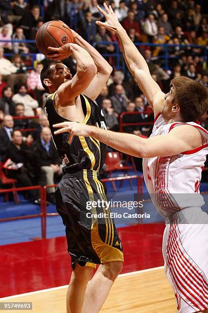 Marko Jaric, #8 of Real Madrid competes shoots over Jeffrey Viggiano, #20 of Armani Jeans Milano during the Euroleague Basketball Regular Season...