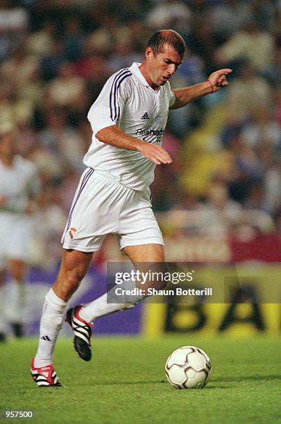 Zinedine Zidane of Real Madrid runs with the ball during the Teresa Herrera tournament match against Deportivo La Coruna played at the Estadio...