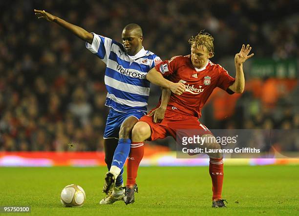 Kalifa Cisse of Reading battles for the ball with Dirk Kuyt of Liverpool during the FA Cup sponsored by E.ON 3rd Round Replay match between Liverpool...