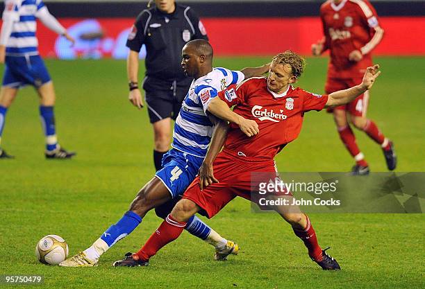 Dirk Kuyt of Liverpool competes for the ball with Kalifa Cisse of Reading during the FA Cup 3rd round replay match between Liverpool and Reading at...