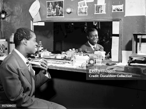 Caption from Down Beat: These are the things that make up Louis Armstrong, as reflected in the mirror by Bill Gottlieb, staff lensman, in the third...