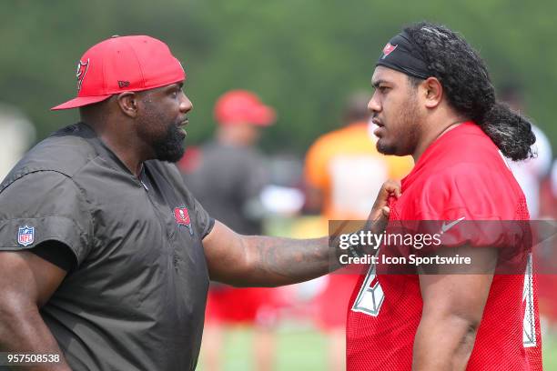 Defensive line coach Brentson Buckner puts his hand on the chest of 2018 first round pick Vita Vea during the Tampa Bay Buccaneers Rookie Minicamp on...