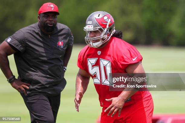 First round pick Vita Vea goes thru drills as defensive line coach Brentson Buckner looks on during the Tampa Bay Buccaneers Rookie Minicamp on May...