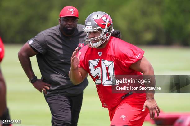 First round pick Vita Vea goes thru drills as defensive line coach Brentson Buckner looks on during the Tampa Bay Buccaneers Rookie Minicamp on May...