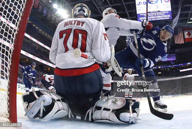 Braden Holtby of the Washington Capitals tends goal against Yanni Gourde of the Tampa Bay Lightning during the first period in Game One of the...