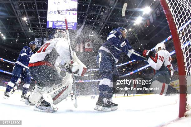 Yanni Gourde of the Tampa Bay Lightning collides with Lars Eller of the Washington Capitals during the first period in Game One of the Eastern...