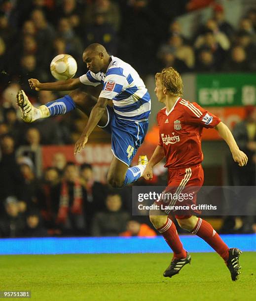 Kalifa Cisse of Reading beats Dirk Kuyt of Liverpool to the ball during the FA Cup sponsored by E.ON 3rd Round Replay match between Liverpool and...