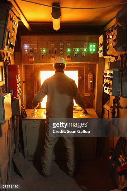 Worker oversees molten iron undergoing purification and alloying to become steel at the ThyssenKrupp steelworks on January 13, 2010 in Duisburg,...