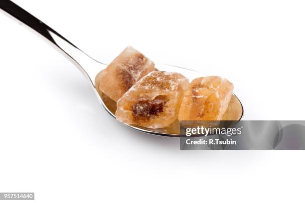 brown caramelized sugar in a wooden spoon on a white background - hyperglycemia stock pictures, royalty-free photos & images
