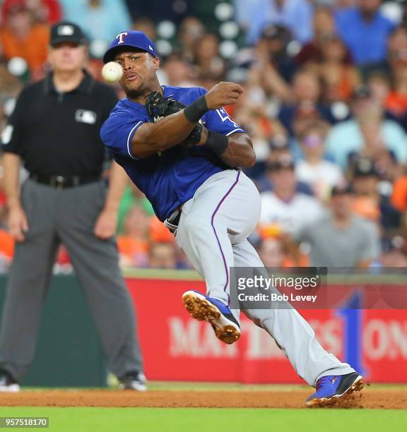 Adrian Beltre of the Texas Rangers throws to first base in the fourth inning attempting to throw out Marwin Gonzalez of the Houston Astros at Minute...