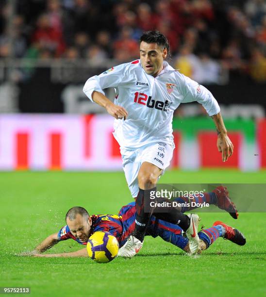 Aldo Duscher of Sevilla beats a fallen Andres Iniesta of Barcelona during the last 16 second leg Copa del Rey match between Barcelona and Sevilla at...