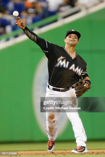 Martin Prado of the Miami Marlins throws out a runner at first base in the fifth inning against the Atlanta Braves at Marlins Park on May 11, 2018 in...