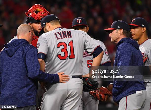 Manager Paul Molitor of the Minnesota Twins looks on as starting pitcher Lance Lynn is checked by medical staff during the third inning of the game...