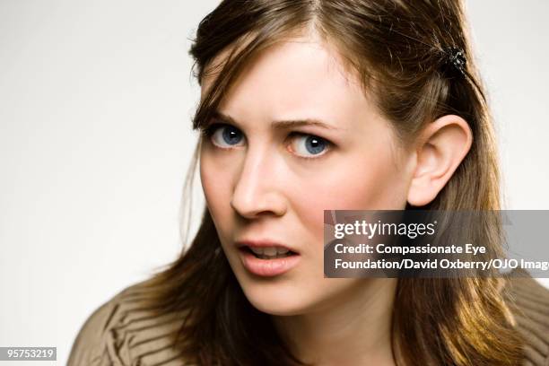 close up of young brunette woman - suspicion fotografías e imágenes de stock