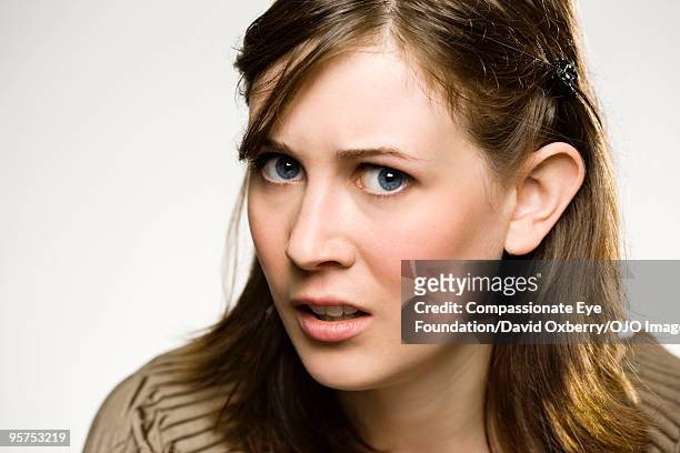 close up of young brunette woman - suspicion stock pictures, royalty-free photos & images