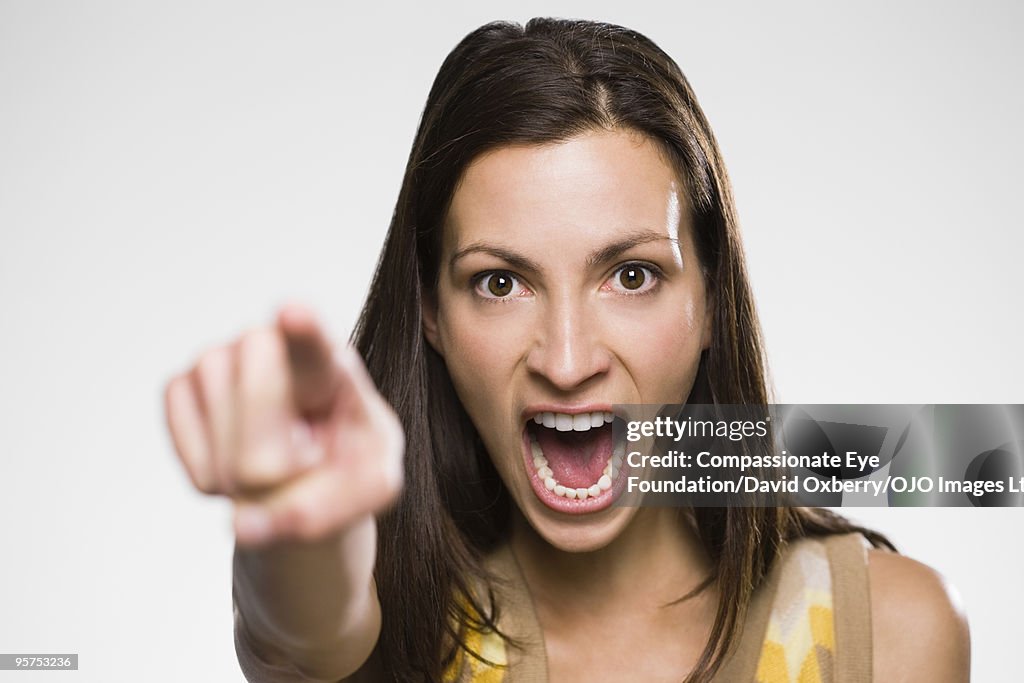 Portrait of woman yelling and pointing
