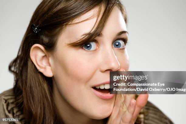 close up of young woman - whispering stock pictures, royalty-free photos & images