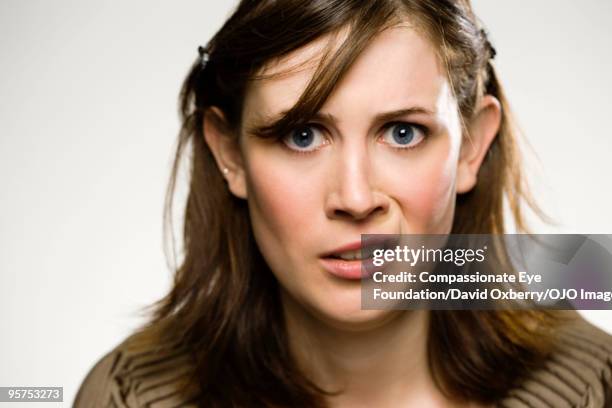 young woman making a facial expression - grimacing stock pictures, royalty-free photos & images