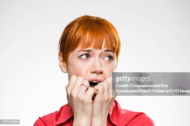 close up of red haired woman - fear stock pictures, royalty-free photos & images