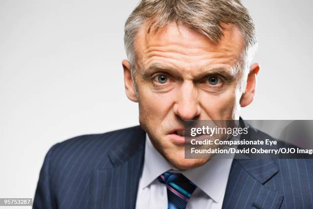 portrait of grey haired man in a suit - clenching teeth stock pictures, royalty-free photos & images