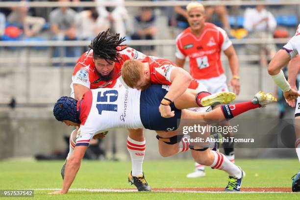 Hamish Stewart of the Reds is tackled by Shota Horie and Edward Quirk of the Sunwolves during the Super Rugby match between Sunwolves and Reds at...