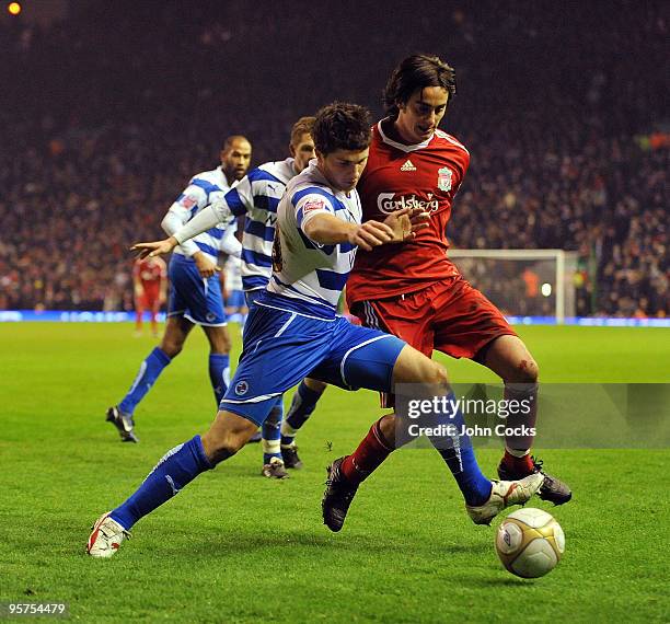 Alberto Aquilani of Liverpool competes for the ball with Shane Long of Reading during the FA Cup 3rd round replay match between Liverpool and Reading...