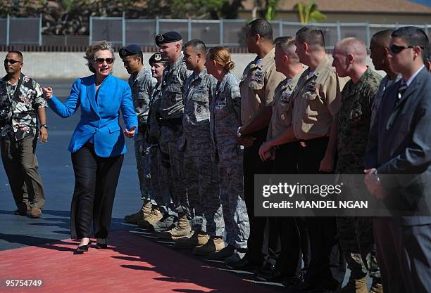 Secretary of State Hillary Clinton greets military personnel who drove vehicles in her motorcade before boarding a flight January 13, 2010 from...