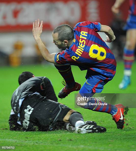 Andres Iniesta of Barcelona is stopped by Sevilla goalkeeper Andres Palop during the last 16 second leg Copa del Rey match between Barcelona and...