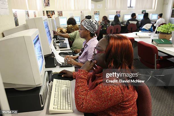 Job seeker Floxy Gold looks at a computer at the South Los Angeles WorkSource Center where US Commerce Secretary Gary Locke announced a $7.5 million...