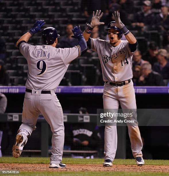 Manny Pina celebrates with teammate left fielder Hernan Perez after hitting a two-run home run against the Colorado Rockies closer Wade Davis to tie...